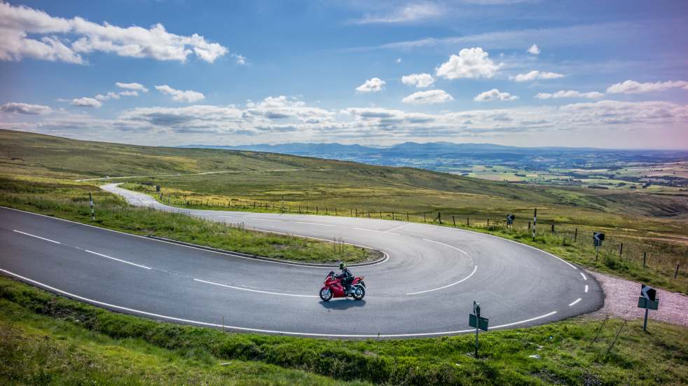 Riding motorbike around bend